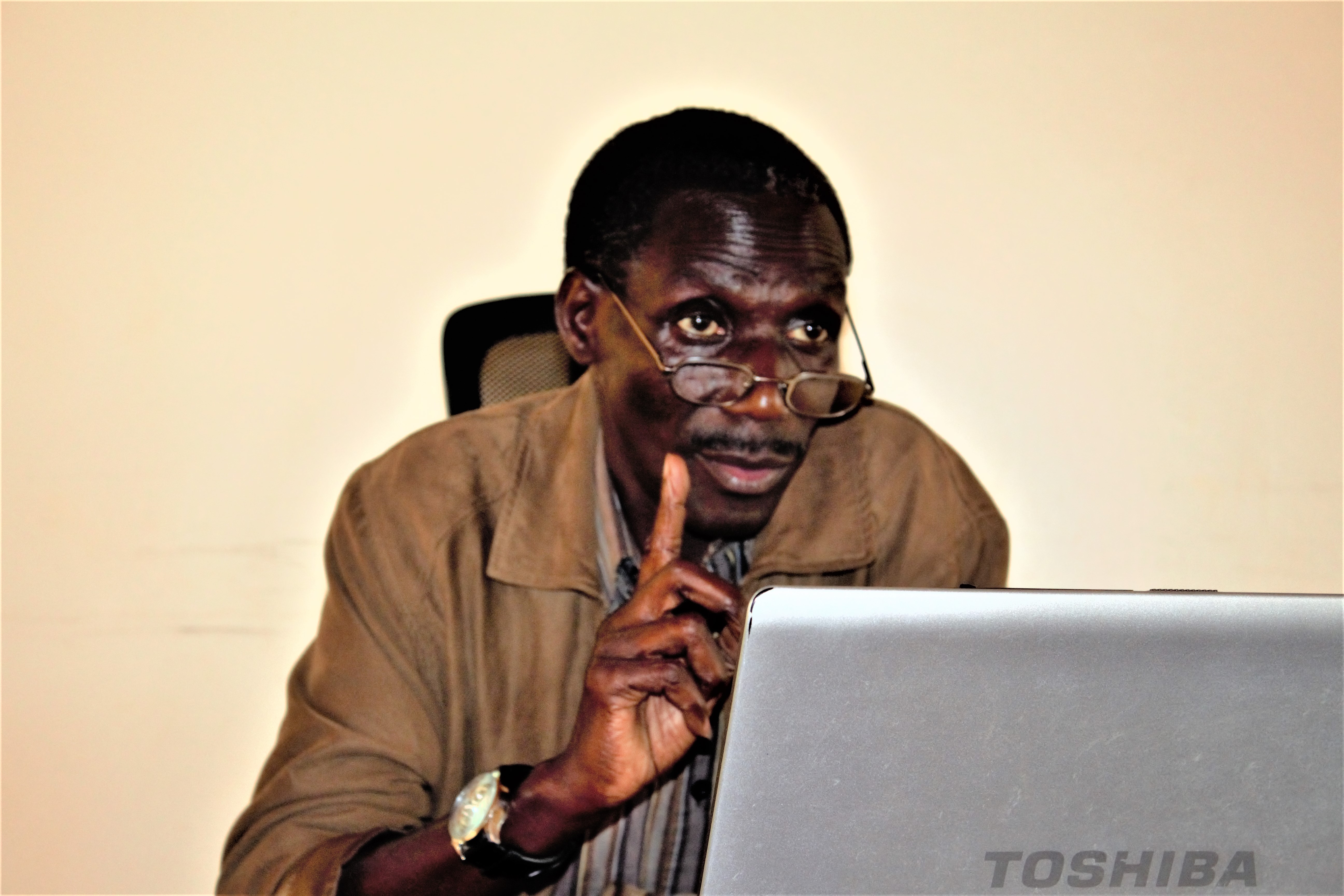 Bob Anyuru, Director Democratic Governance and Accountability explains the activities of Landnet Uganda and what Land Observatory means to Data Collection   Informants during training at Foyer De Charite, Namugongo Uganda.